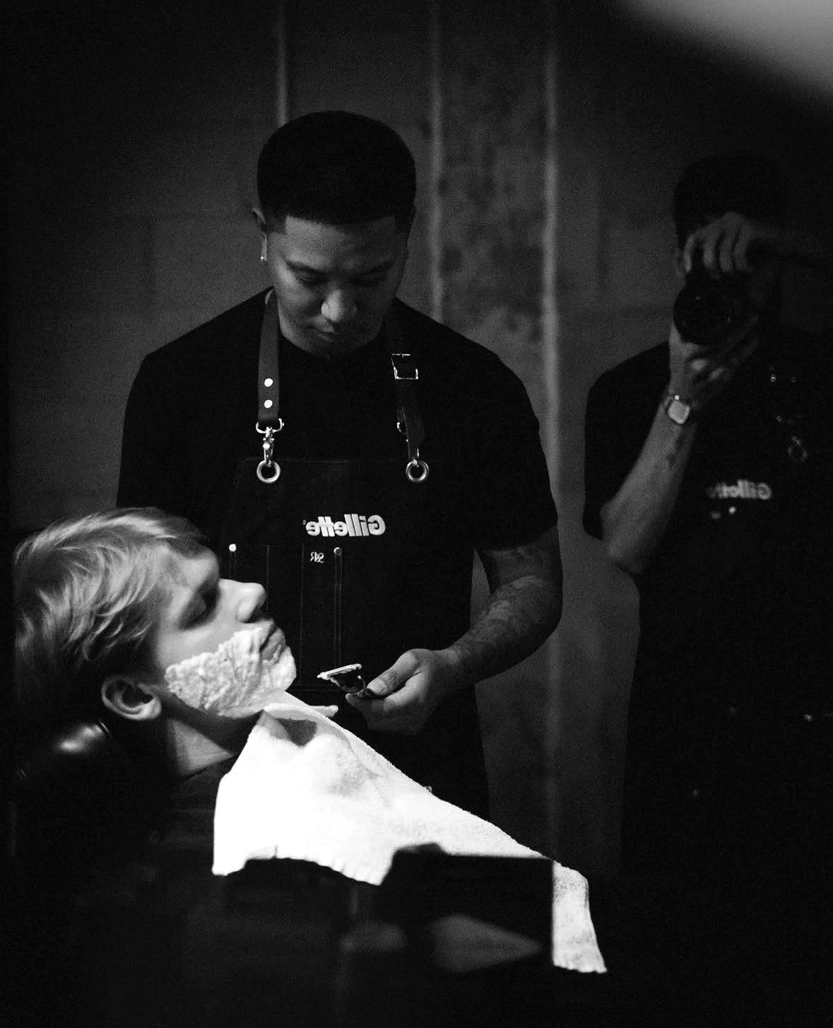 A Throne barber preparing a client for a shave