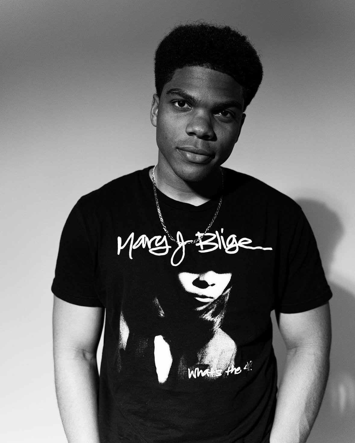 Black-and-white portrait of Spence Moore II in a dark T-shirt