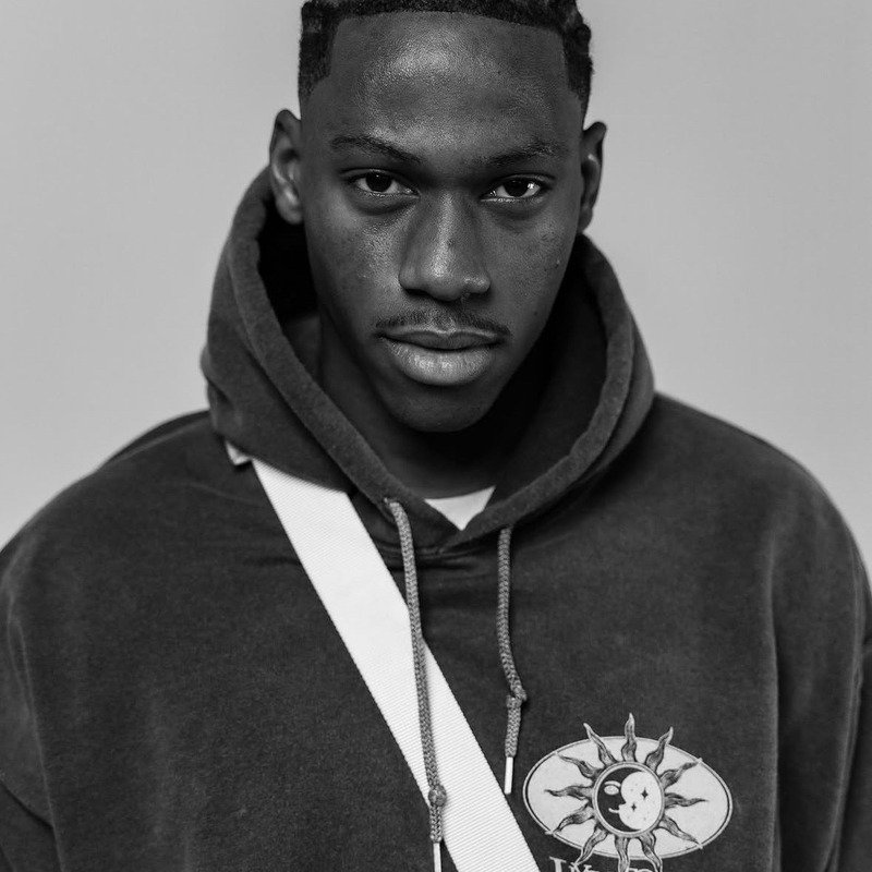 Black-and-white studio portrait from Throne Barbershop
