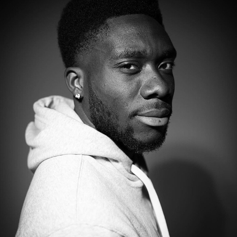 Black-and-white studio portrait from Throne Barbershop