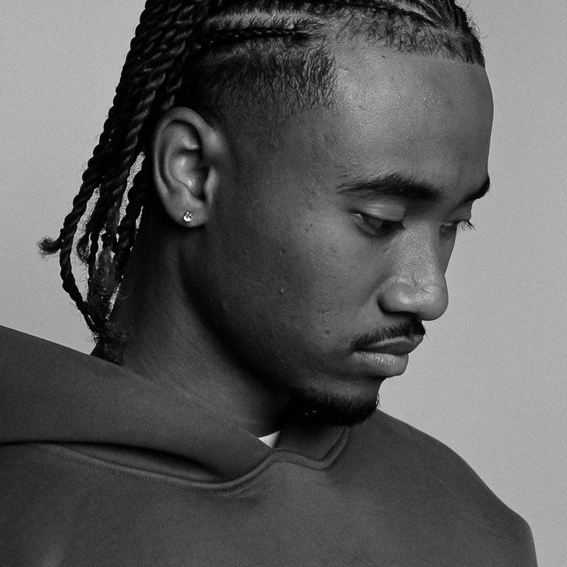 Black-and-white studio portrait from Throne Barbershop