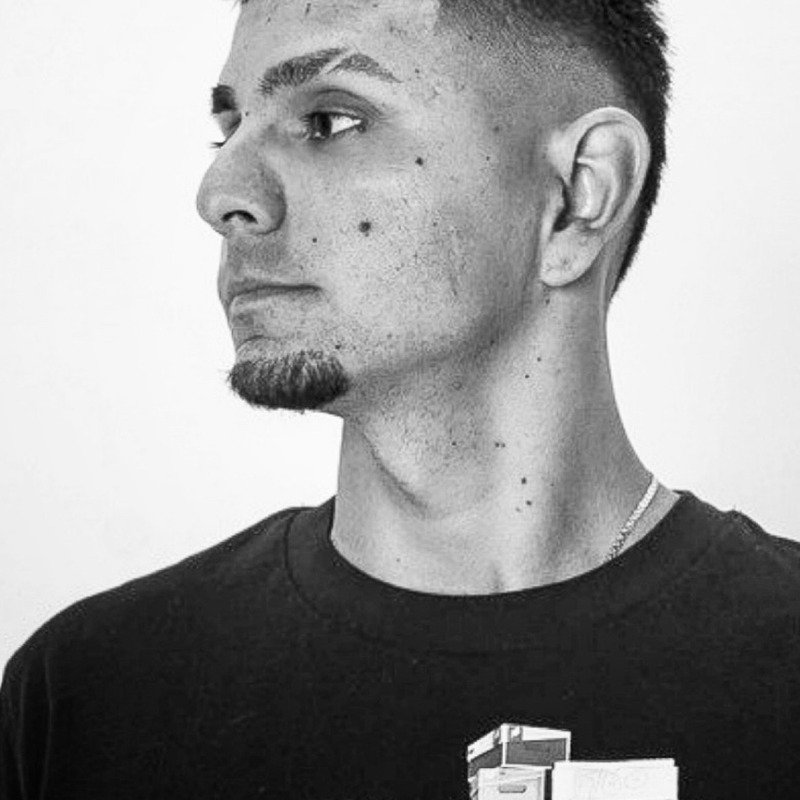 Black-and-white studio portrait from Throne Barbershop