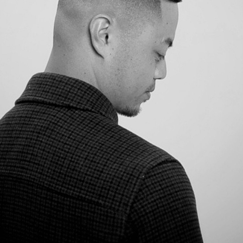 Black-and-white studio portrait from Throne Barbershop