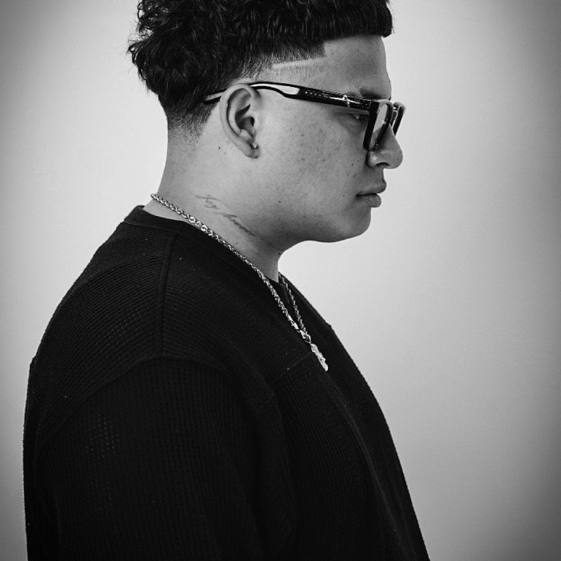 Black-and-white studio portrait from Throne Barbershop