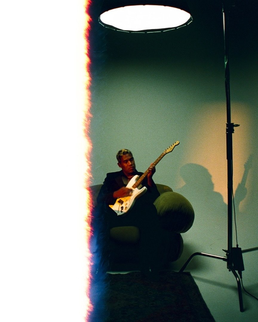 Musician with a guitar — photo by Adriano Clarke